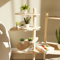 Étagère modulaire en bois clair à plusieurs niveaux pour plantes, conçue pour s'adapter et s'ajouter aux tables Canopée Design.
