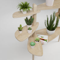 Étagère modulaire en bois clair à plusieurs niveaux pour plantes, conçue pour s'adapter et s'ajouter aux tables Canopée Design.